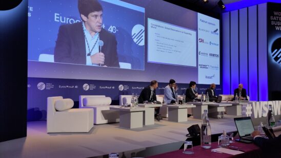 WSBW 2023's “Constellations: Global Observation in an Expanding World.” panel, with Francisco Vilhena da Cunha featured on the big screen. Courtesy Euroconsult