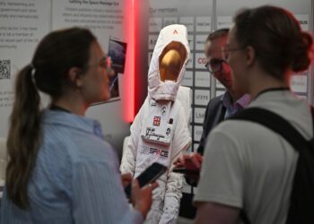 A cardboard cutout of an astronaut on a stand during the Space-Comm Expo in Farnborough, UK, in 2023. (Courtesy/ Bloomberg)